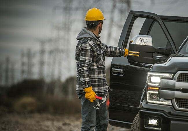 energy industry worker next to his pickup truck