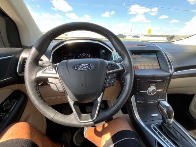 Side profile of 2018 Ford Edge Titanium parked near Conroe TX, ready for test drive