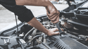 Car mechanic working on car engine