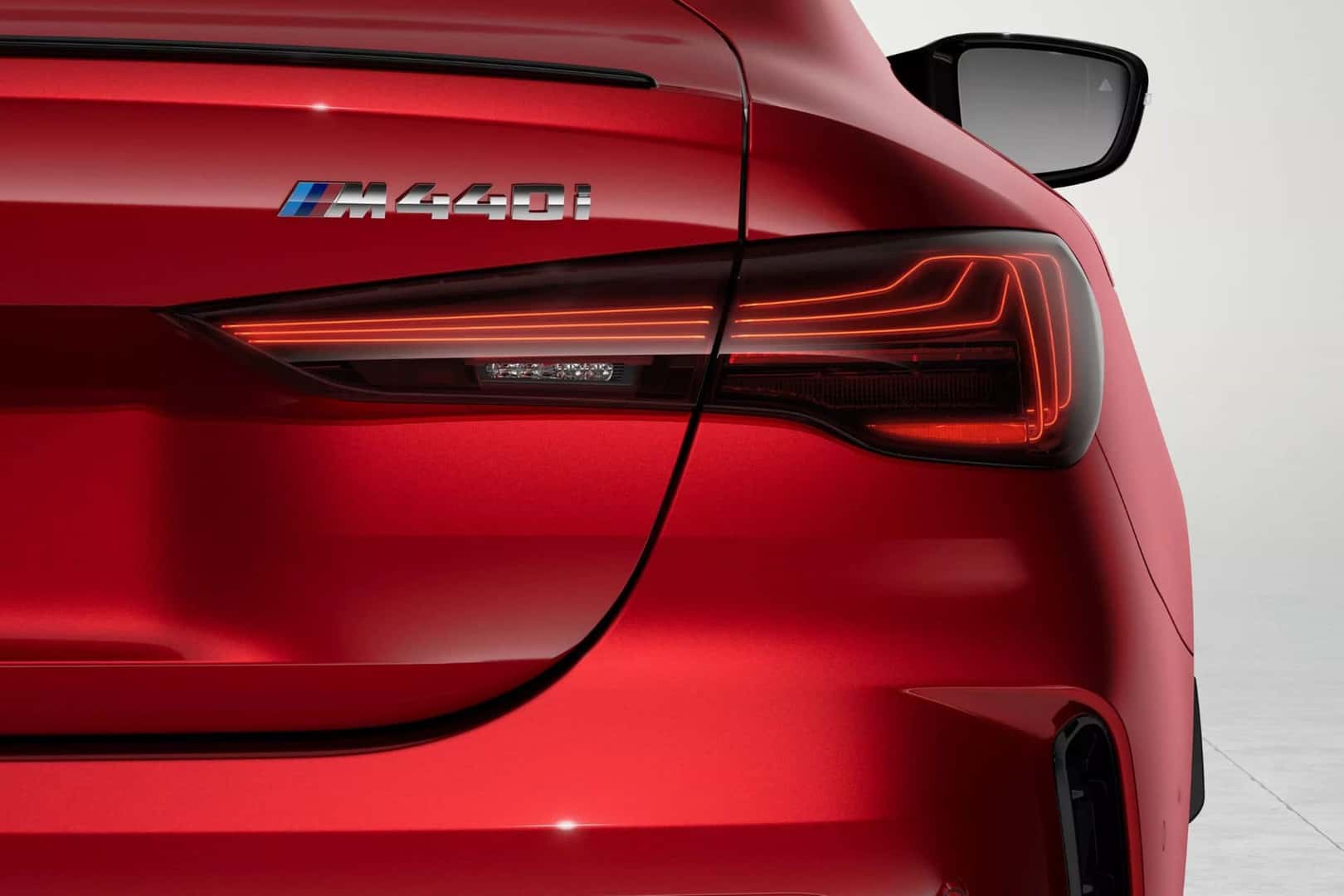 close up of the bmw 4 series coupe's rear, featureing LED taillights and the M440i badge