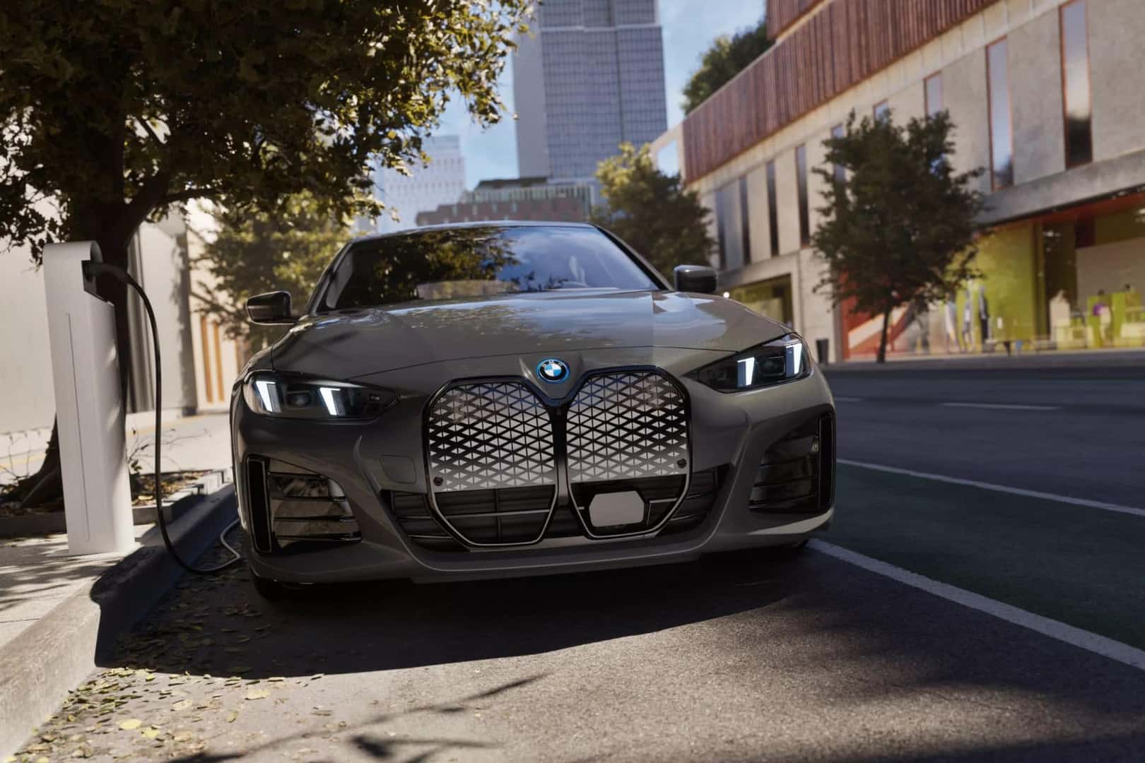bmw i4 parked at a charging station, highlighting its sleek grille and modern LED headlights