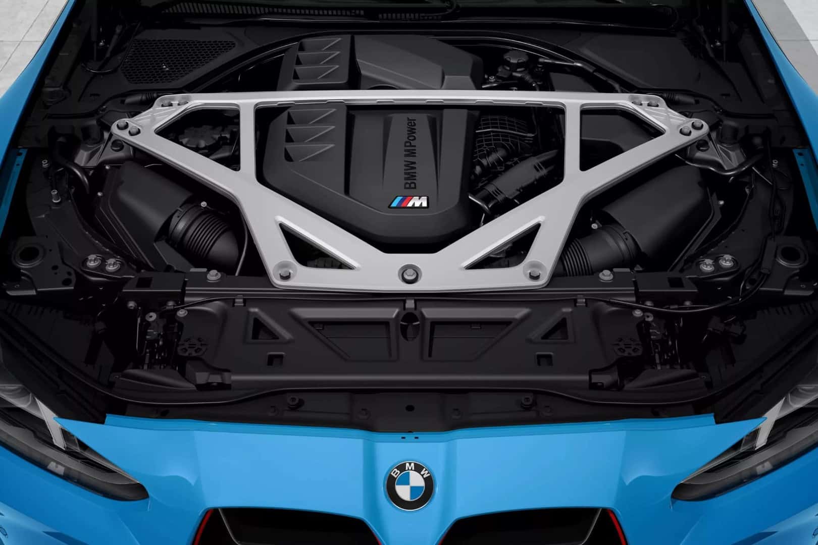 BMW M4 engine bay with the BMW M Power engine and structural support brace for enhanced performance.