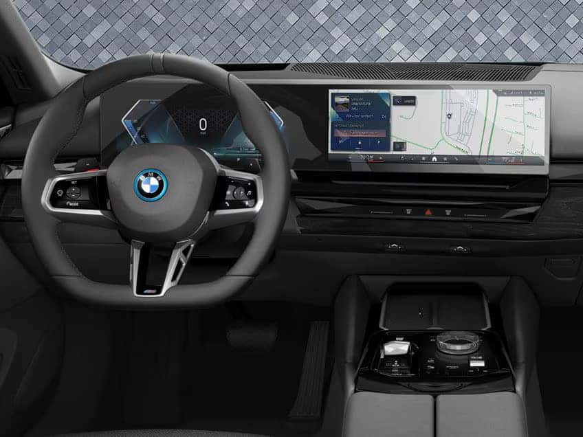 BMW 5 Series digital dashboard with navigation screen and modern steering wheel design.