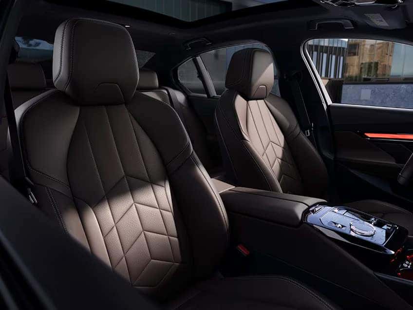 BMW 5 Series luxury interior featuring quilted leather seats and ambient lighting.