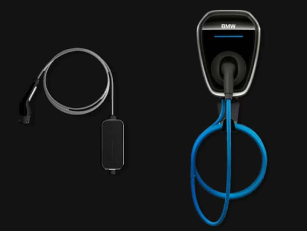 BMW electric vehicle home charging station with cable and portable charger.