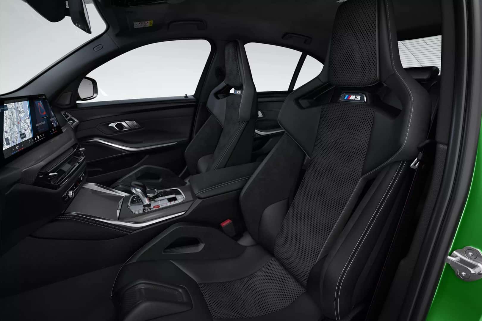 Interior view of the BMW M3 showcasing premium carbon fiber bucket seats and modern dashboard design.