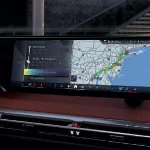 infotainment curved display on a bmw ix showcasing temperature, navigation and traffic information
