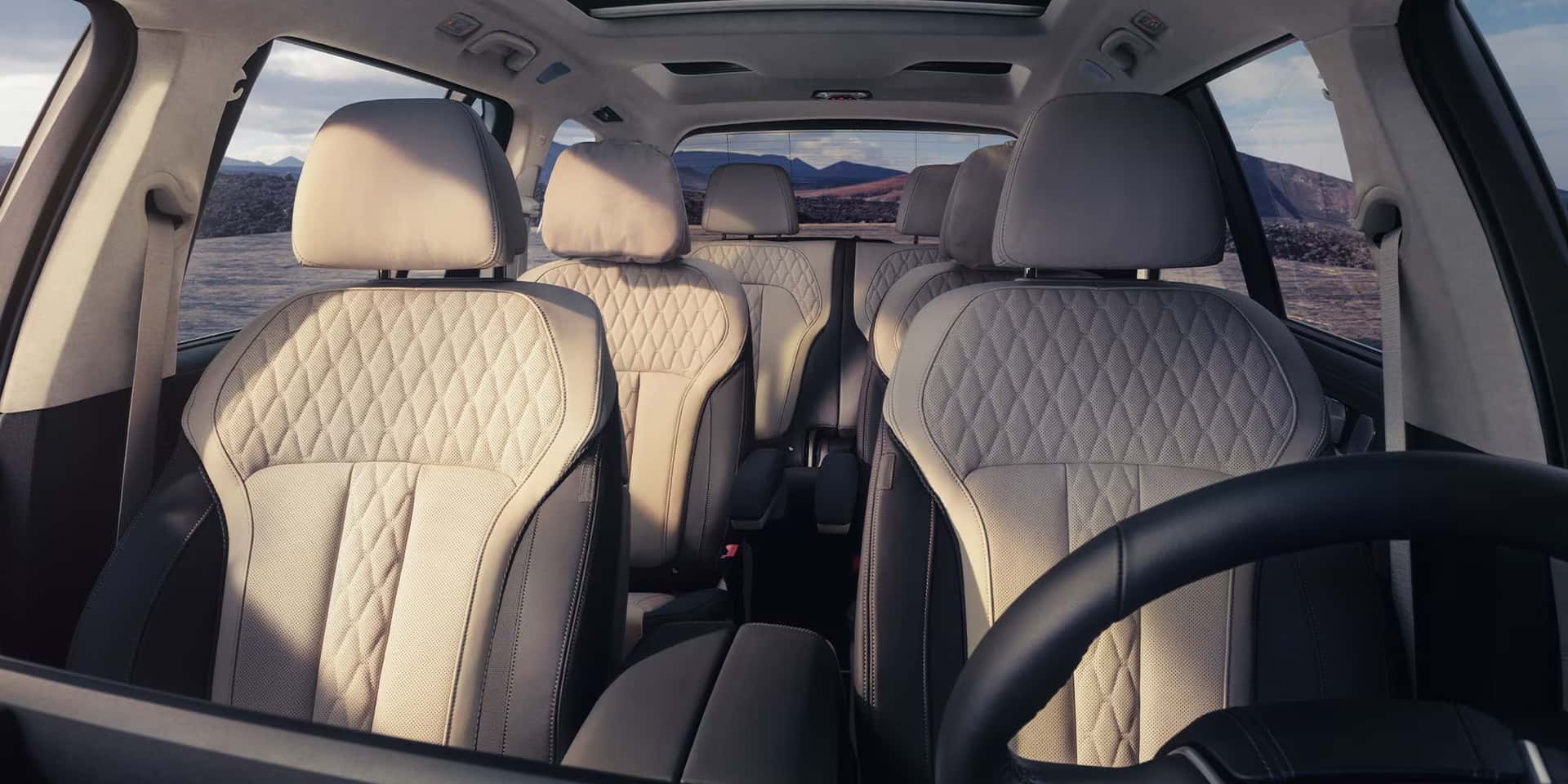 the interior of a 2026 bmw x7 looking back from the front seats. 