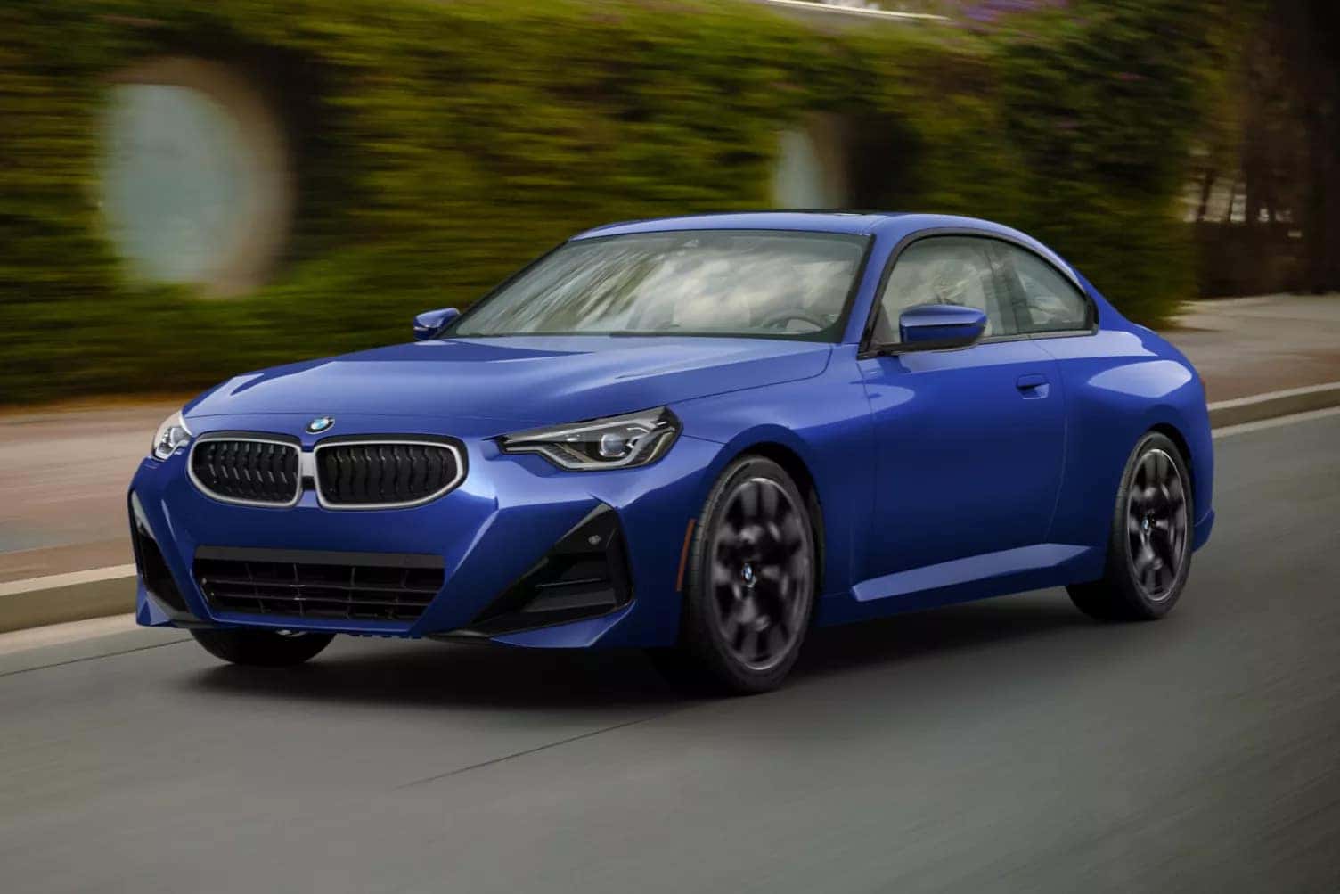 2026 BMW 2 Series driving on a road in the city