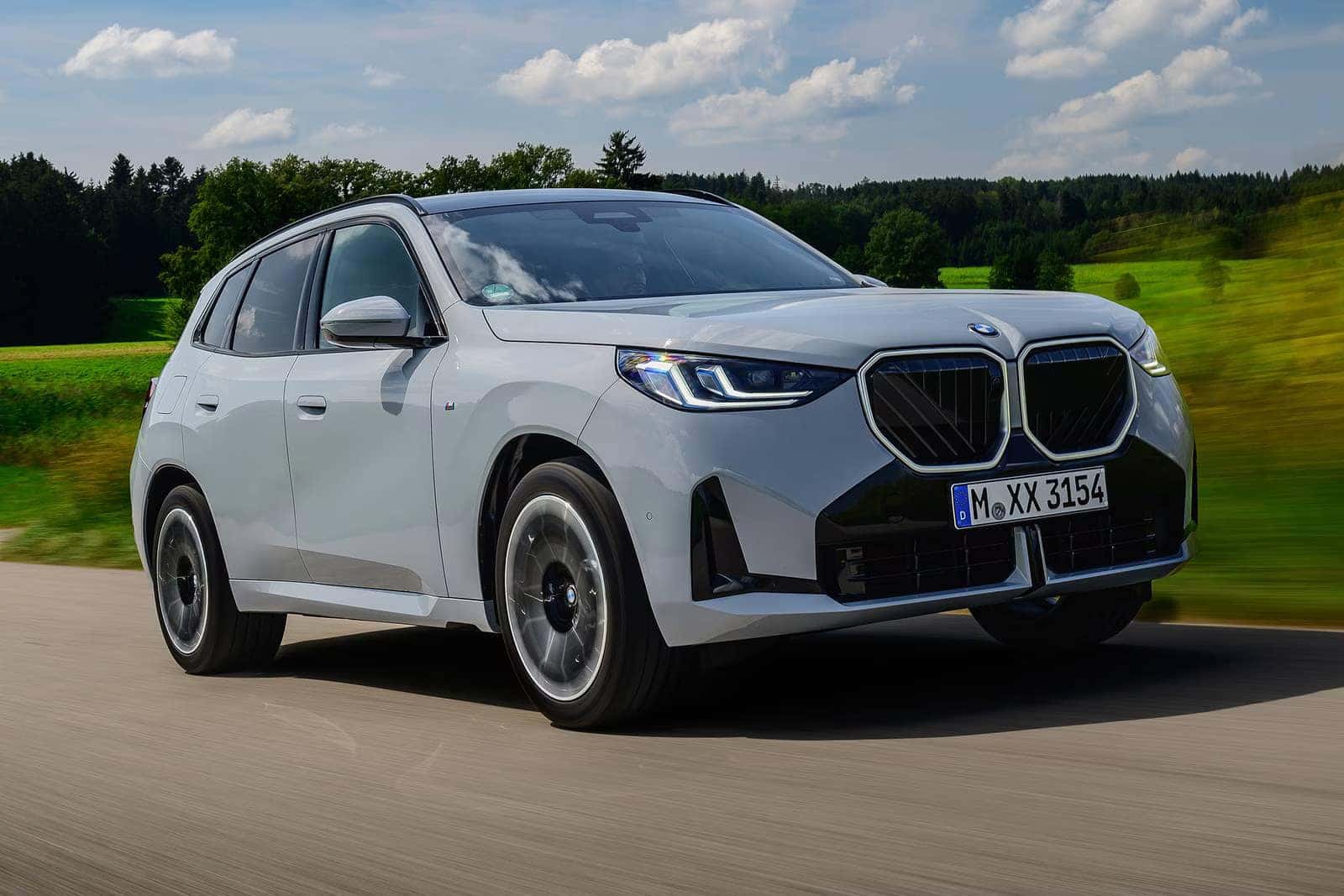 2026 BMW X3 driving next to field