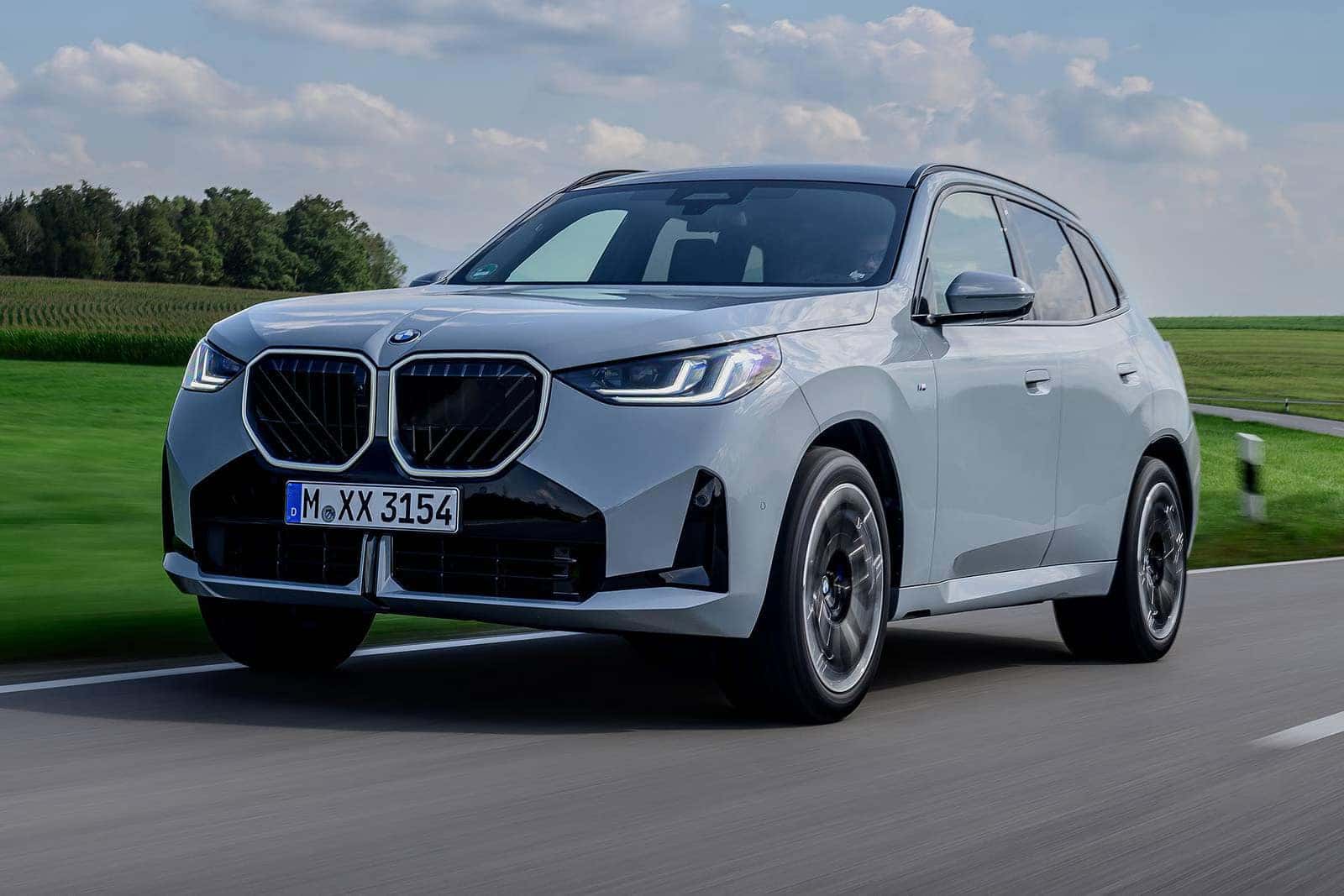 2026 BMW X3 Driving next to an open field
