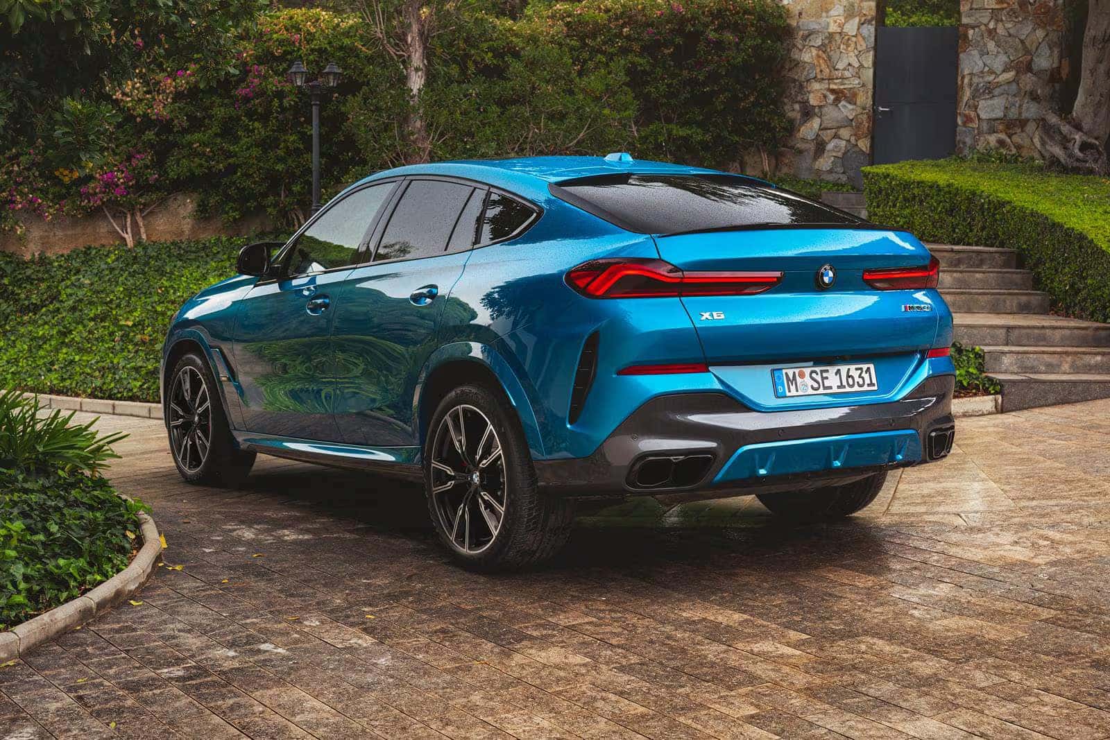 2026 BMW X6 parked in front of a home