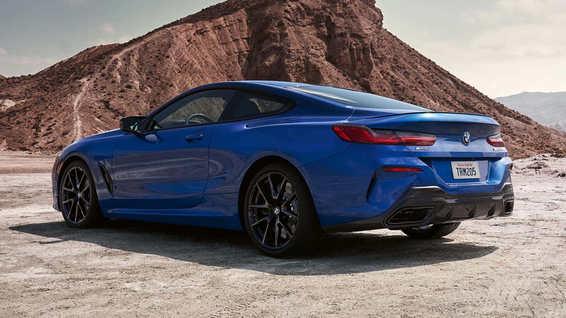 2026 BMW 8 Series parked next to a mountain