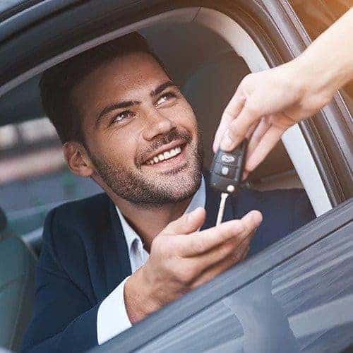 Man smiling receiving keyfob