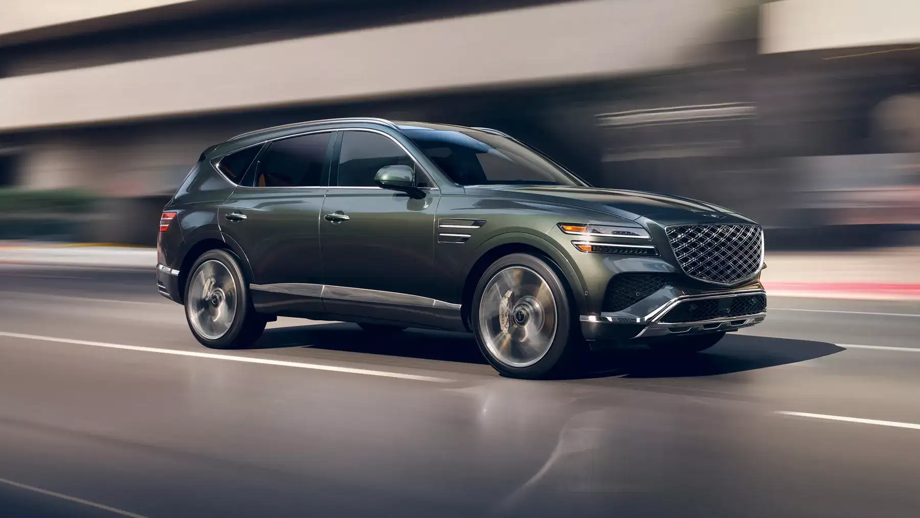 forest green 2026 genesis gv80 driving on a freeway