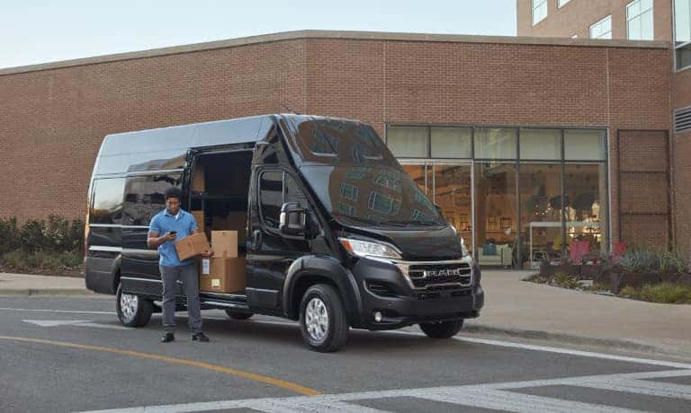 2026 Ram ProMaster parked by business with driver