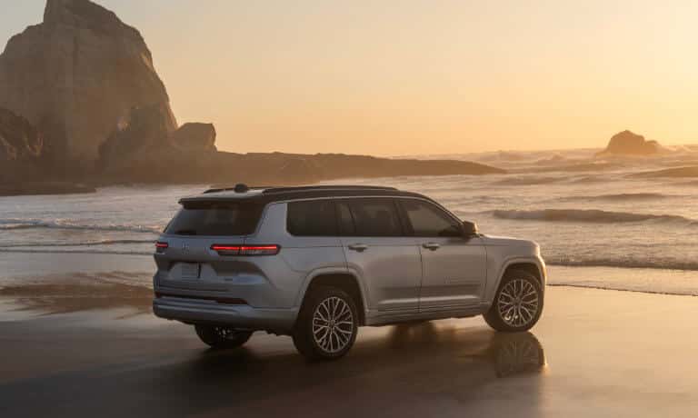 2026 Jeep Grand Cherokee facing ocean rocks