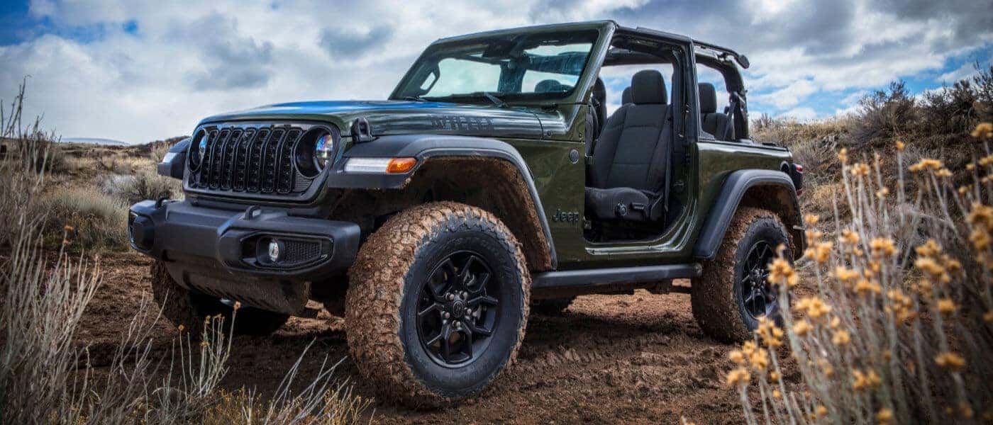 2026 Jeep Wrangler in a field with doors off