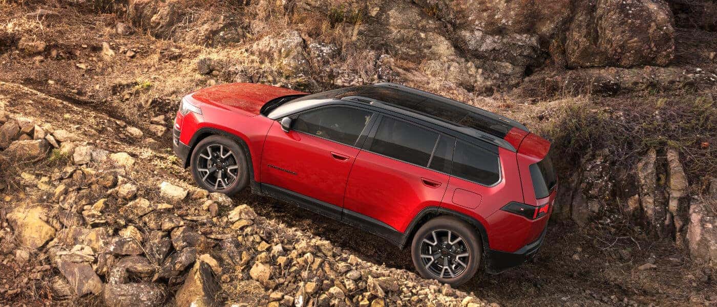 2026 Jeep Cherokee driving up rocky incline