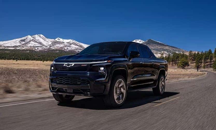New Chevrolet Silverado EV Driving Through Mountain Range