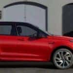 2022landrover_discovery-sideview-driving-by-cafe-umbrellas-red-mobile