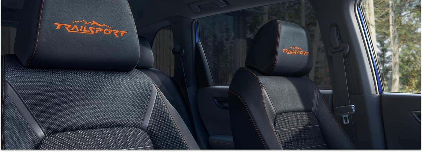 Black front seats with orange TrailSport embroidered headrests inside a 2026 Honda CR-V.