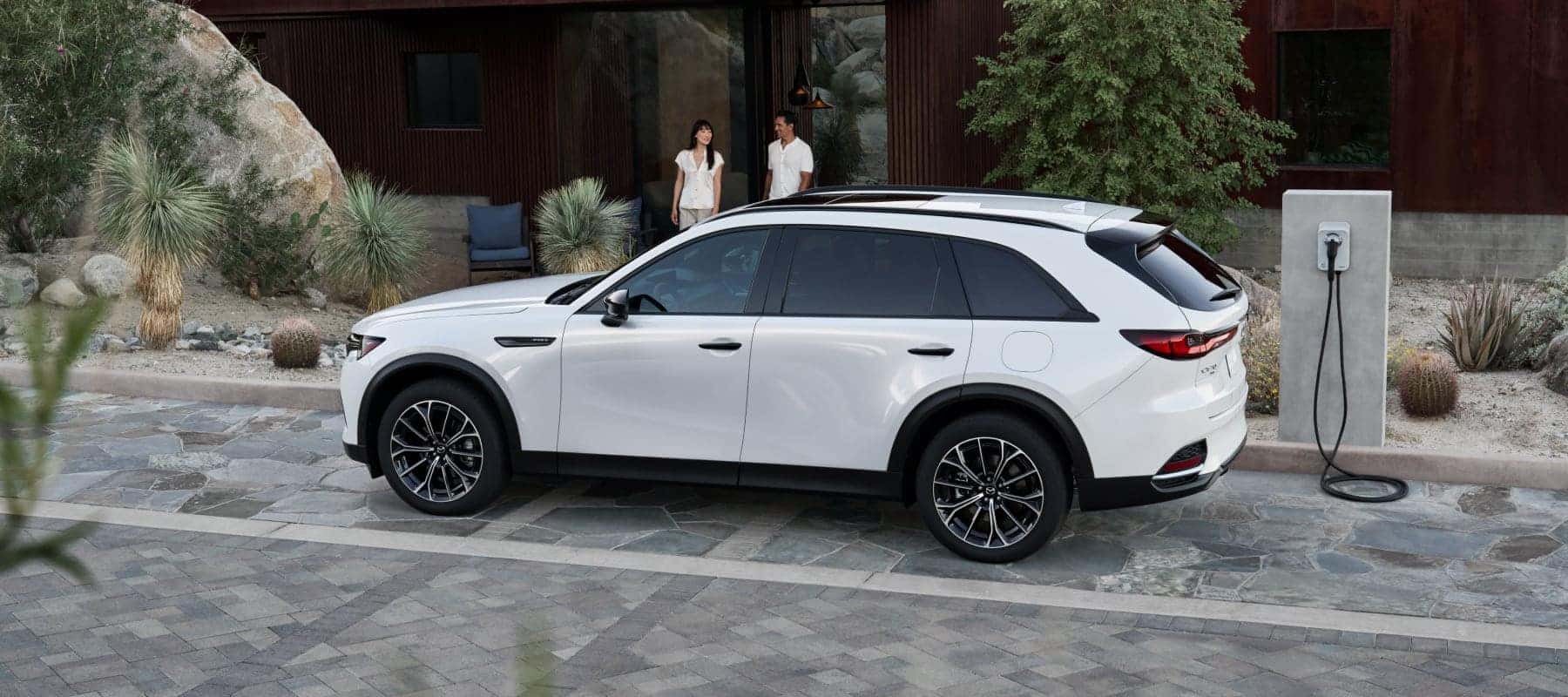 white suv in front of house