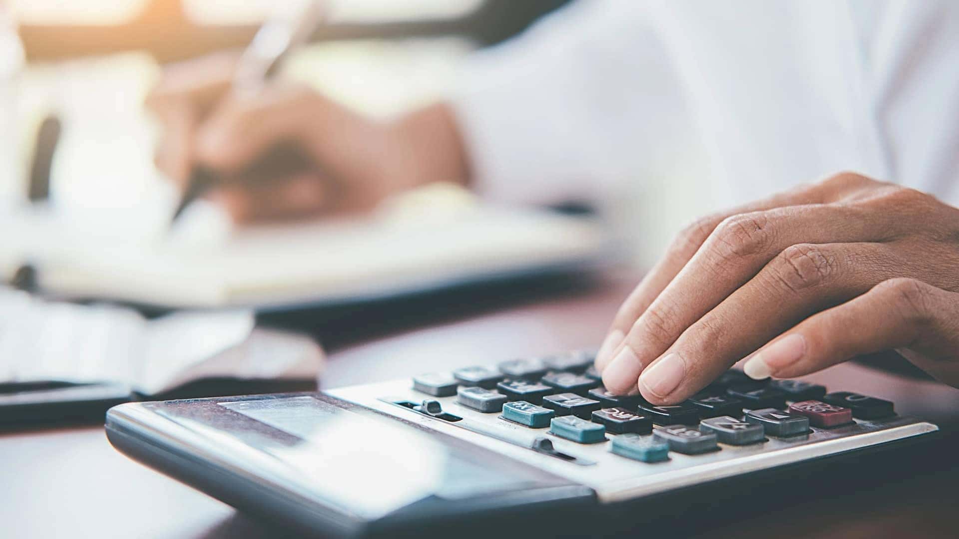 man using calculator in office