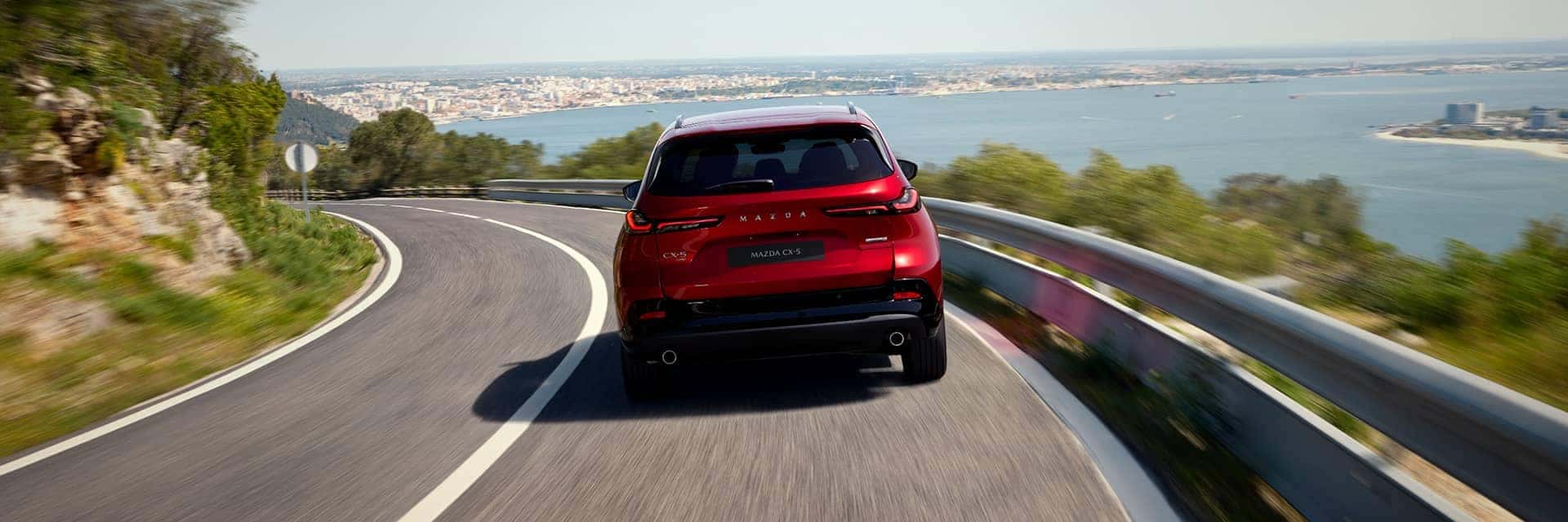 red mazda cx-5 driving on road