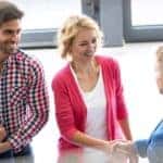 Family with a Young Child Shaking Hands with Salesman