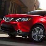 Red Nissan Rogue in the city