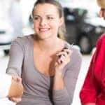 Young Woman with Parents Buying Car