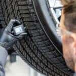 GMC technician measuring tire tread