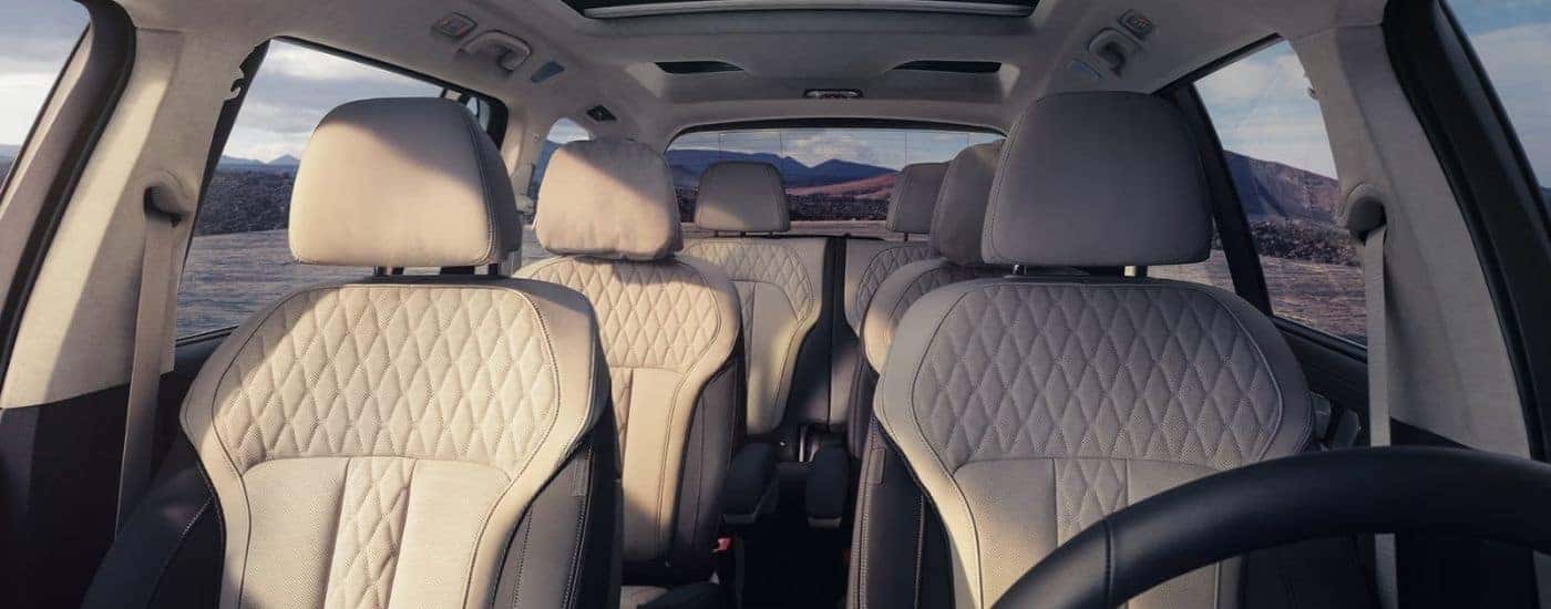 Three rows of seating inside a BMW X7 for sale.