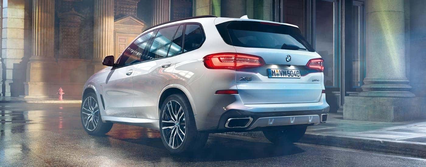 A white 2021 BMW X5 for sale is shown parked near a curb.