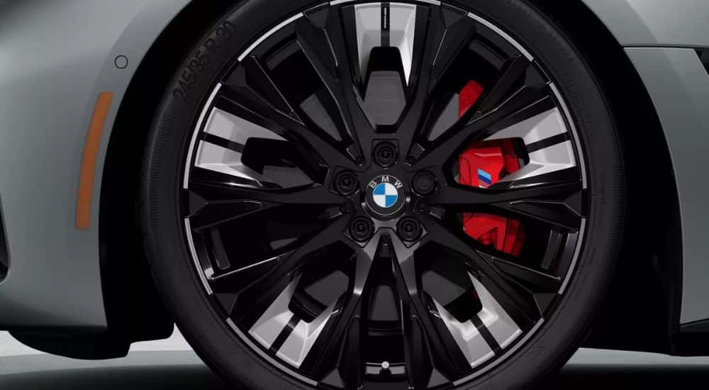 Close-up of the front wheel on a grey 2025 BMW i4 M40.