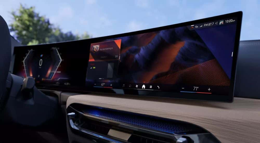 The panoramic infotainment screen in a 2025 BMW i4 for sale.