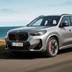 A silver 2025 BMW X1 for sale is shown from the front at an angle.