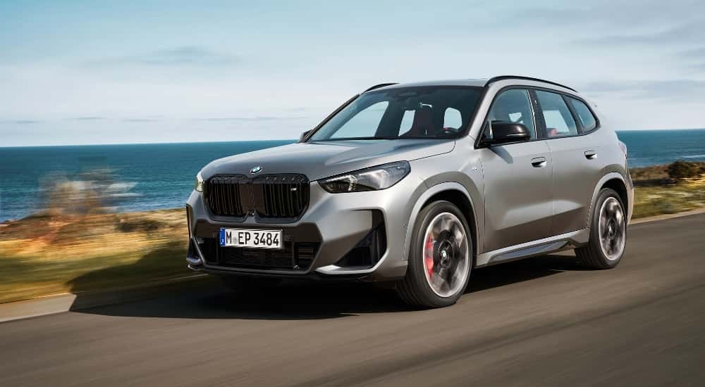 A silver 2025 BMW X1 for sale is shown from the front at an angle.