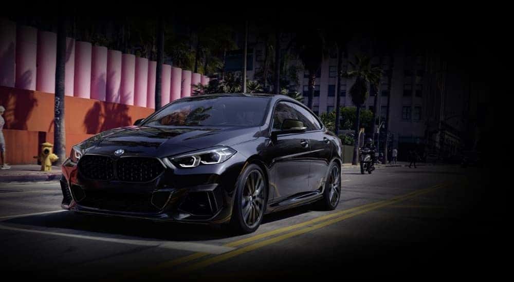 A black 2021 used BMW 2 Series Gran Coupe for sale in Roanoke driving on a street.