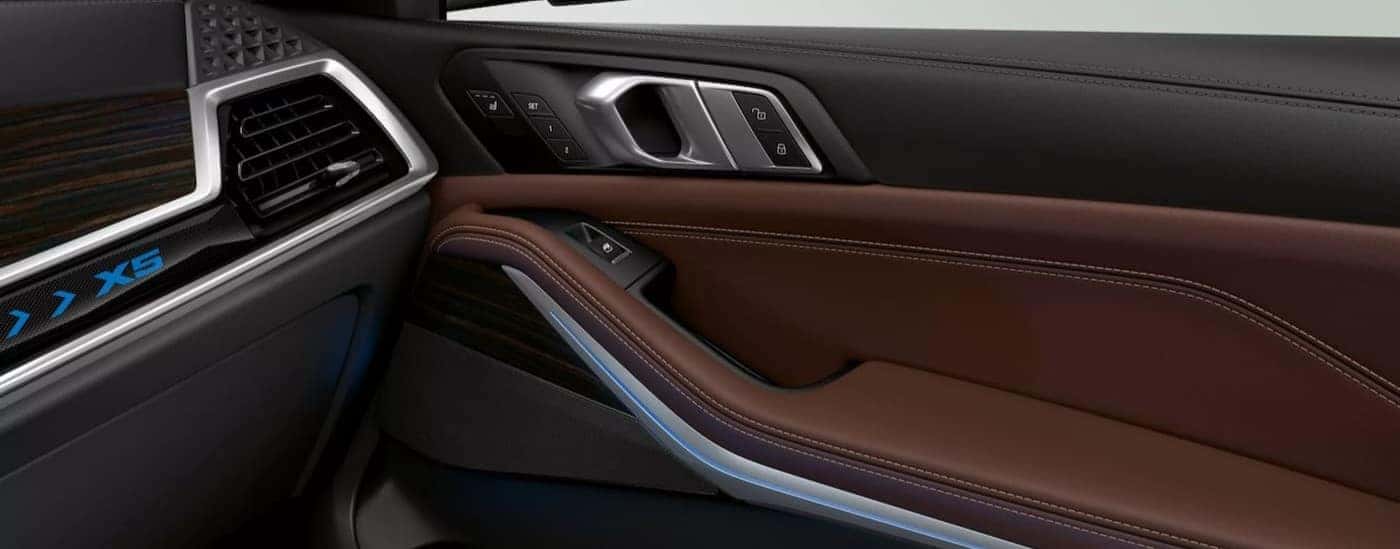 Interior view of a black and brown door in a 2026 BMW X5.