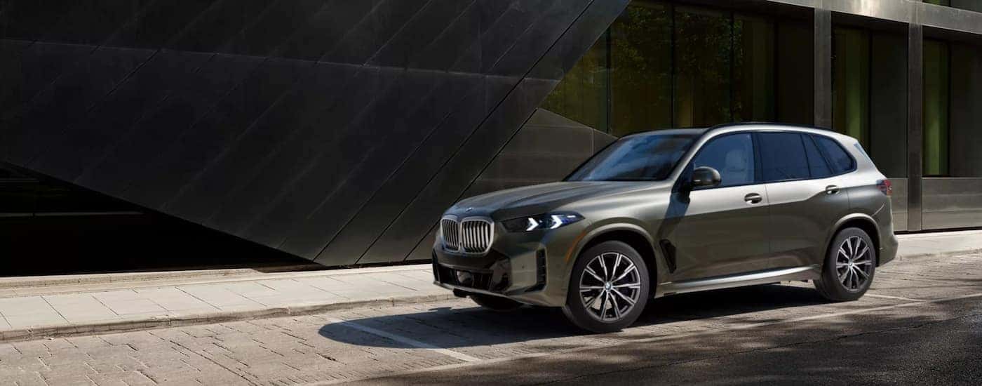 A green 2026 BMW X5 for sale near Salem is parked.