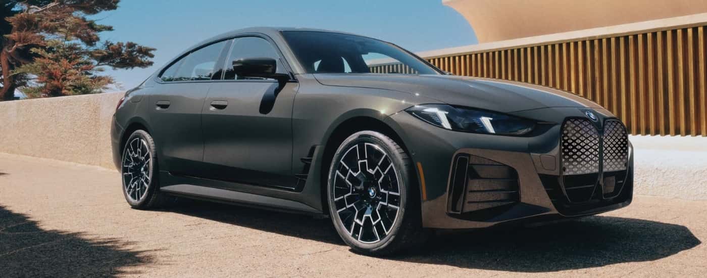 A grey 2025 BMW i4 parked and angled right.