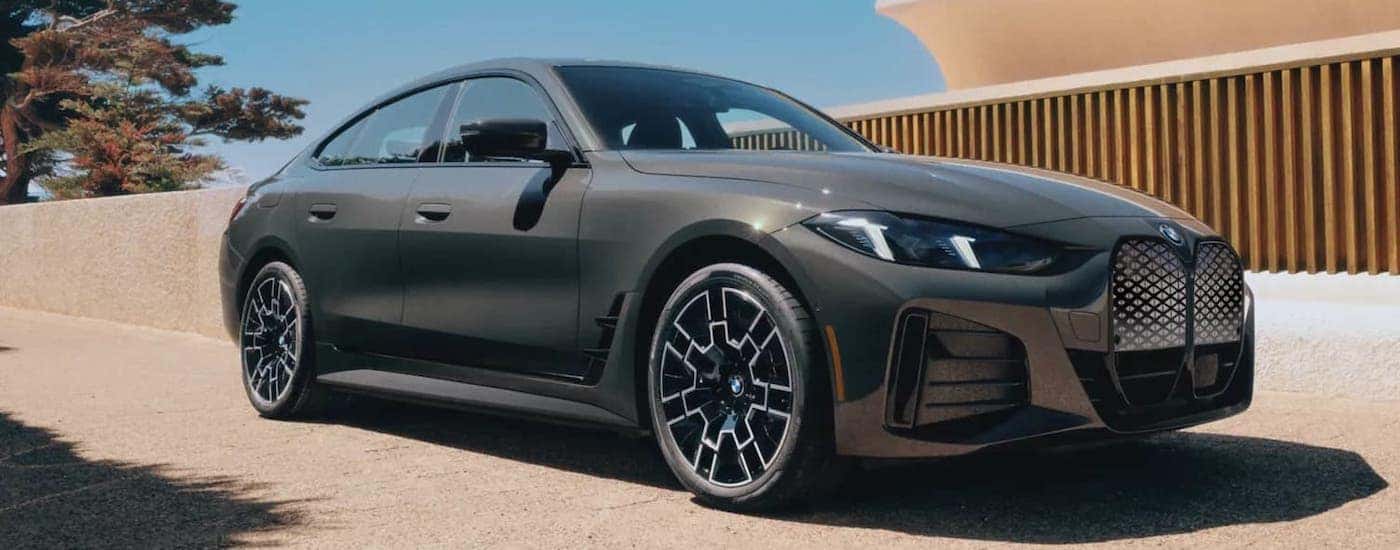 Grey used 2023 BMW 4 Series for sale near Bedford driving down a street.