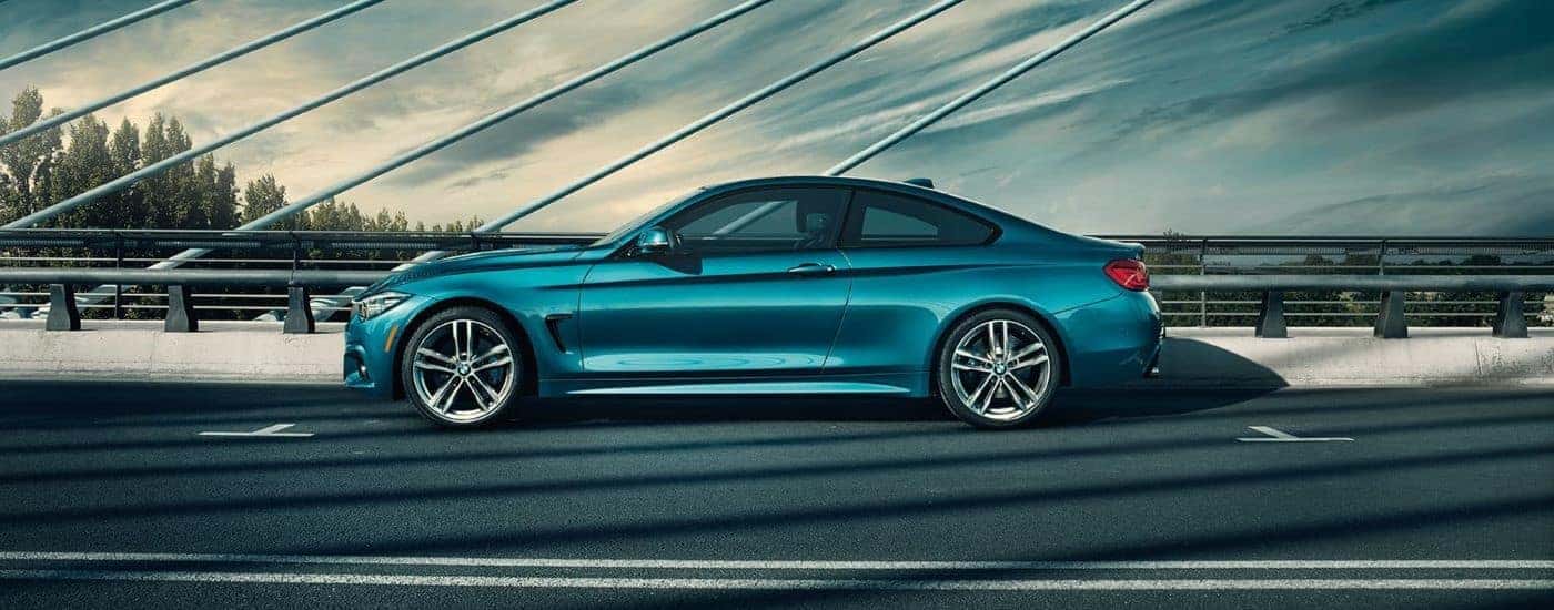 Blue 2019 BMW 4 series driving on a bridge