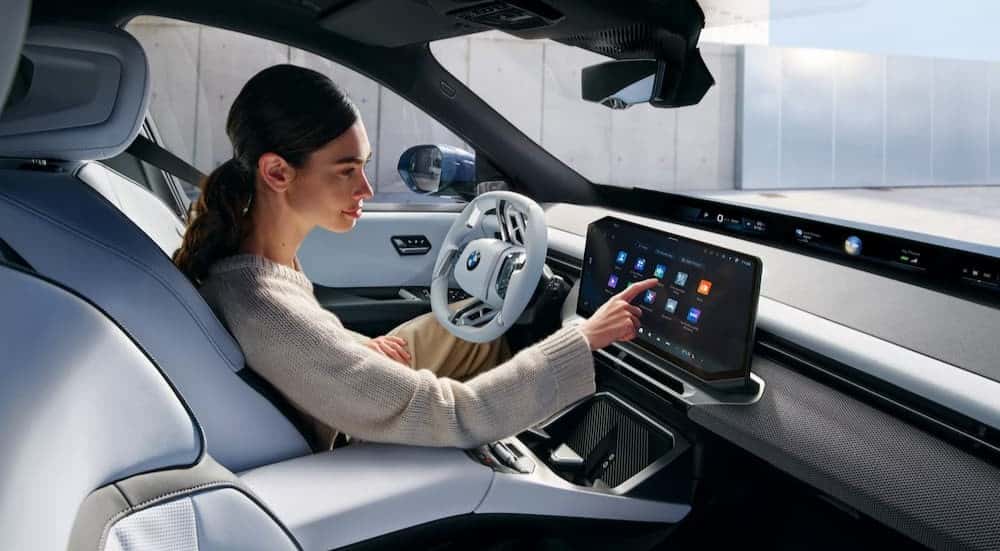 A person driving in a 2027 BMW iX3.