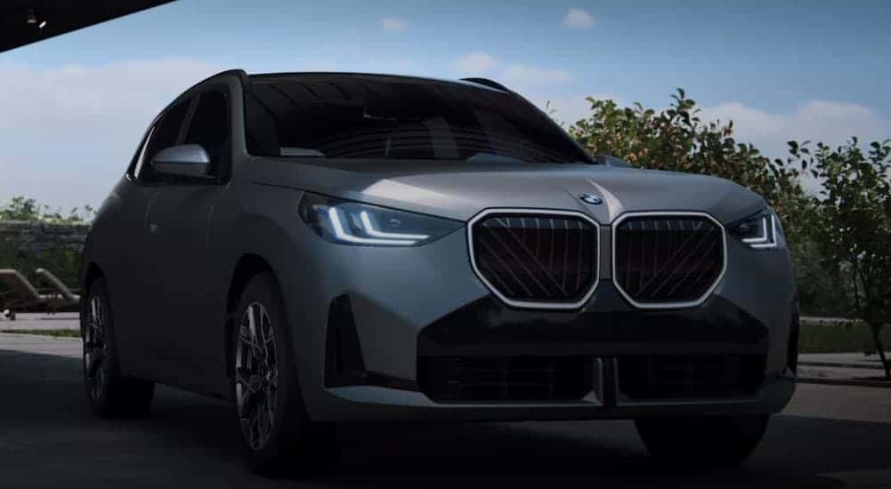 A silver 2025 BMW X3 parked on a driveway.