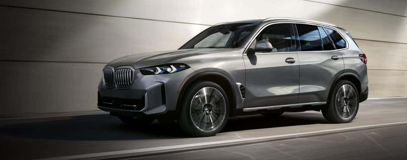 Silver 2024 BMW X5 from the side