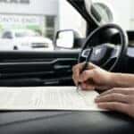 Online pre-qualification application for used RAM truck financing on a laptop at a dealership.