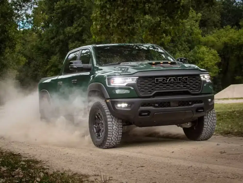 Green 2027 RAM 1500 driving off-road through dust